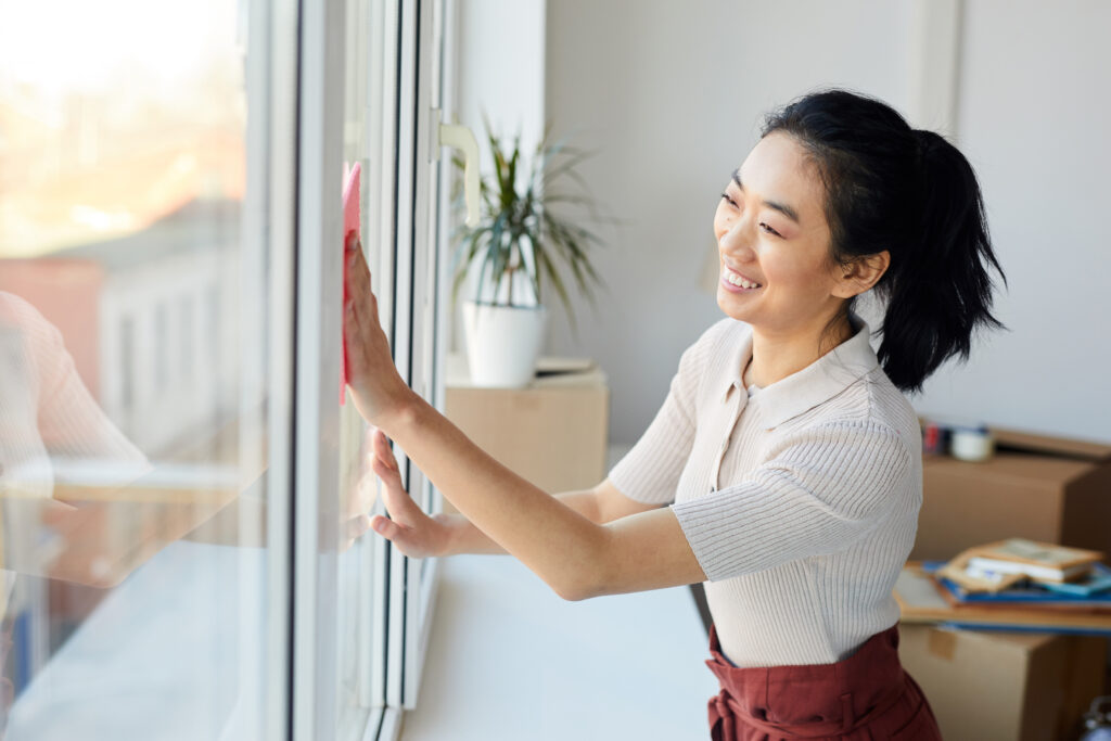 Young Asian Woman Cleaning Windows